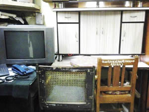 The table and TV set seized by the police from the accused.